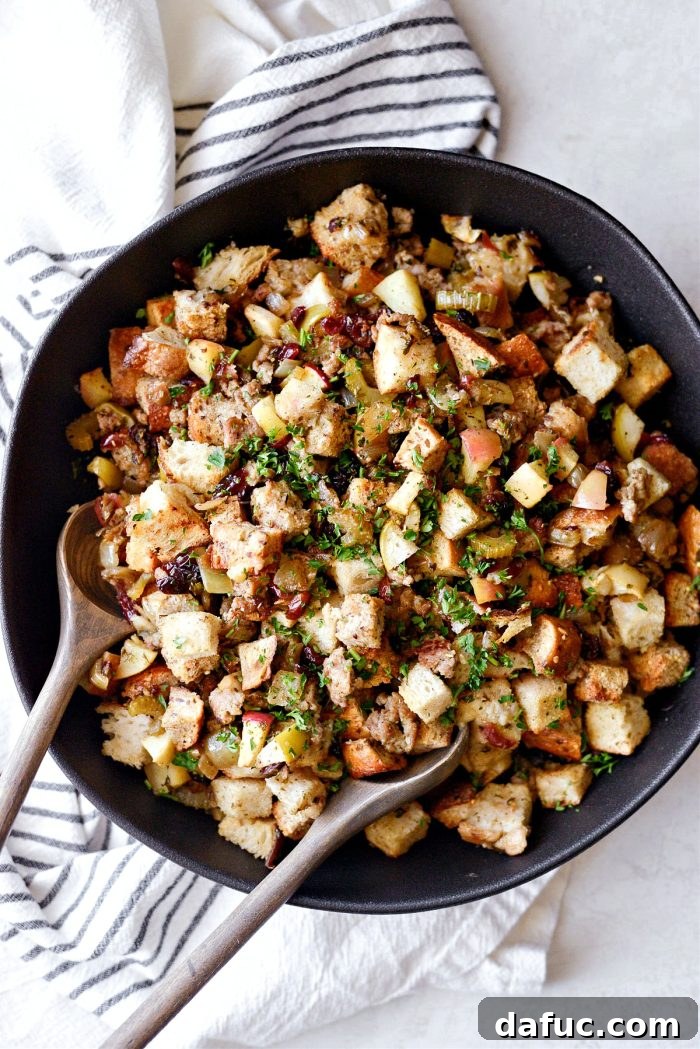 Sausage Apple Cranberry Stuffing served in a white bowl.