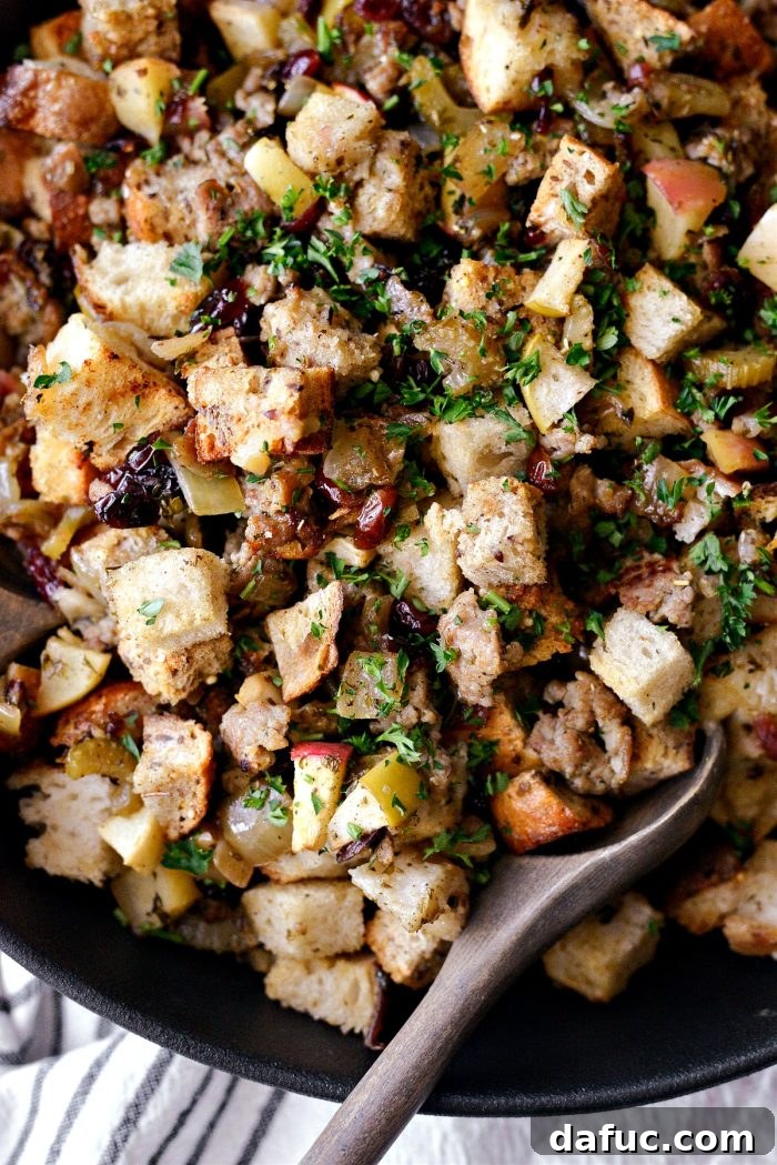 Sausage Apple Cranberry Stuffing on a serving platter with fresh parsley garnish.
