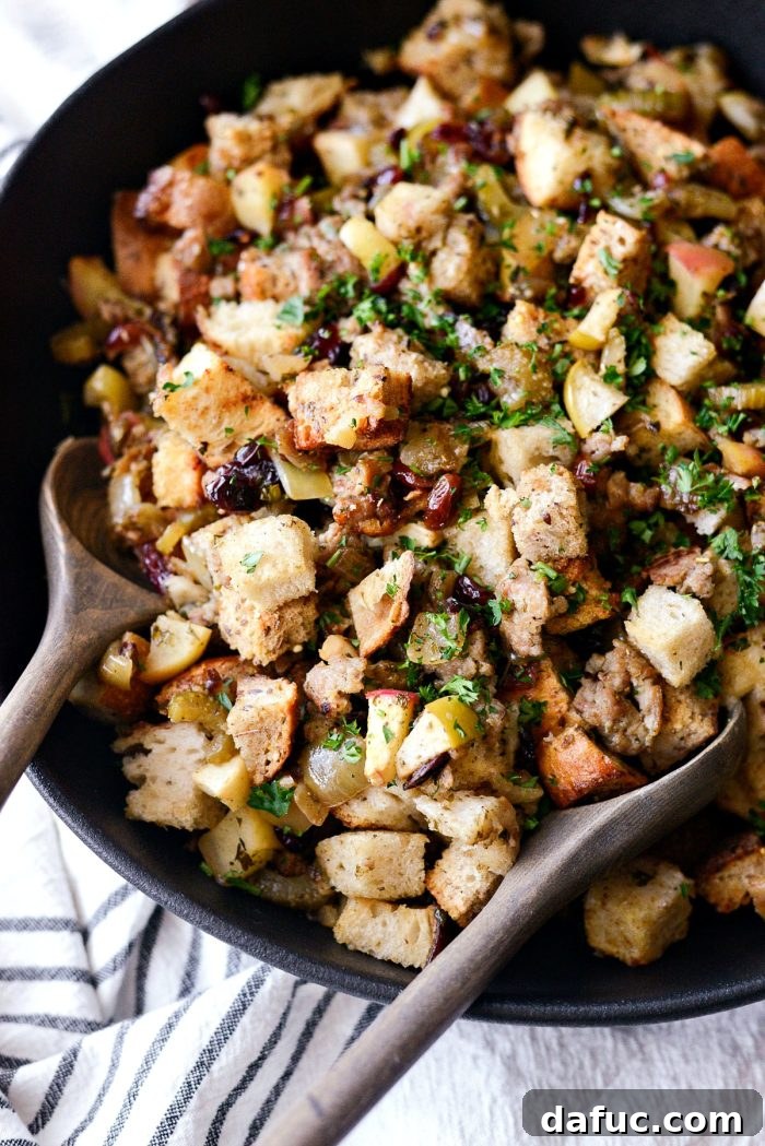Close-up of baked Sausage Apple Cranberry Stuffing with golden brown top.