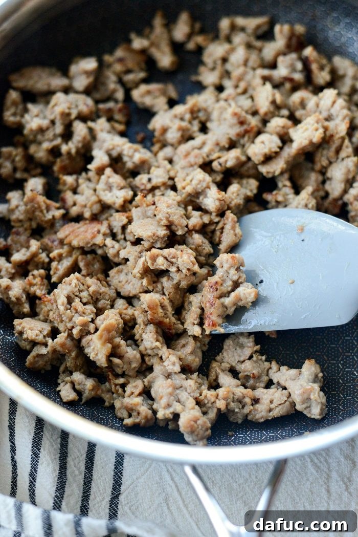 Cubed bread drying in a pan in the oven, a key step for crispy stuffing.