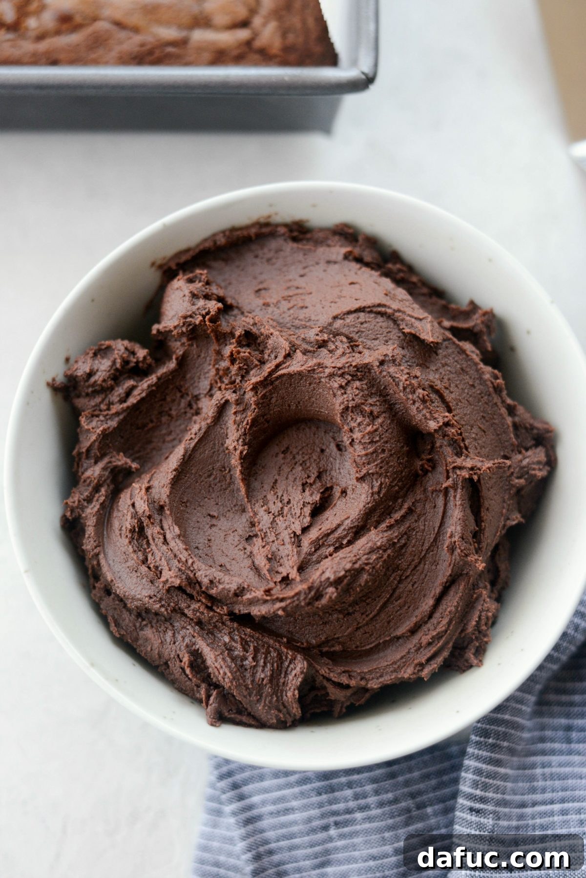 Silky Smooth Chocolate Frosting 2 Velvety smooth homemade chocolate frosting spread generously on a dessert.