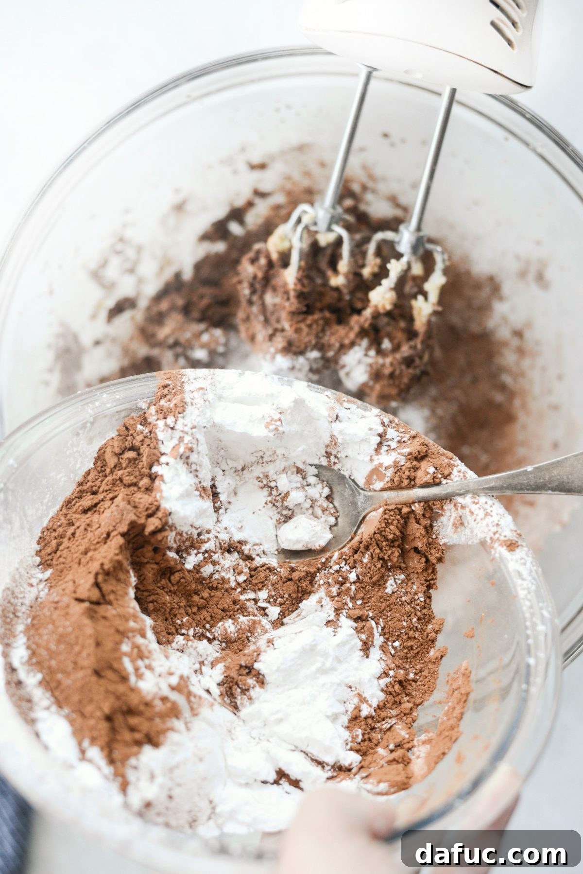 Silky Smooth Chocolate Frosting 12 Mixing cocoa, sugar, and milk into the butter for chocolate frosting.