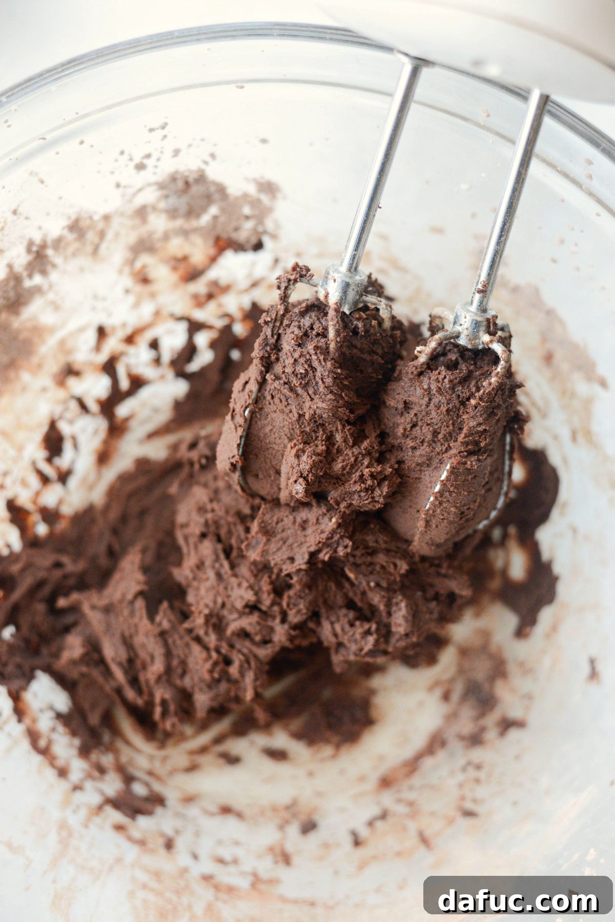 Silky Smooth Chocolate Frosting 13 Chocolate frosting gradually coming together to a smooth consistency.