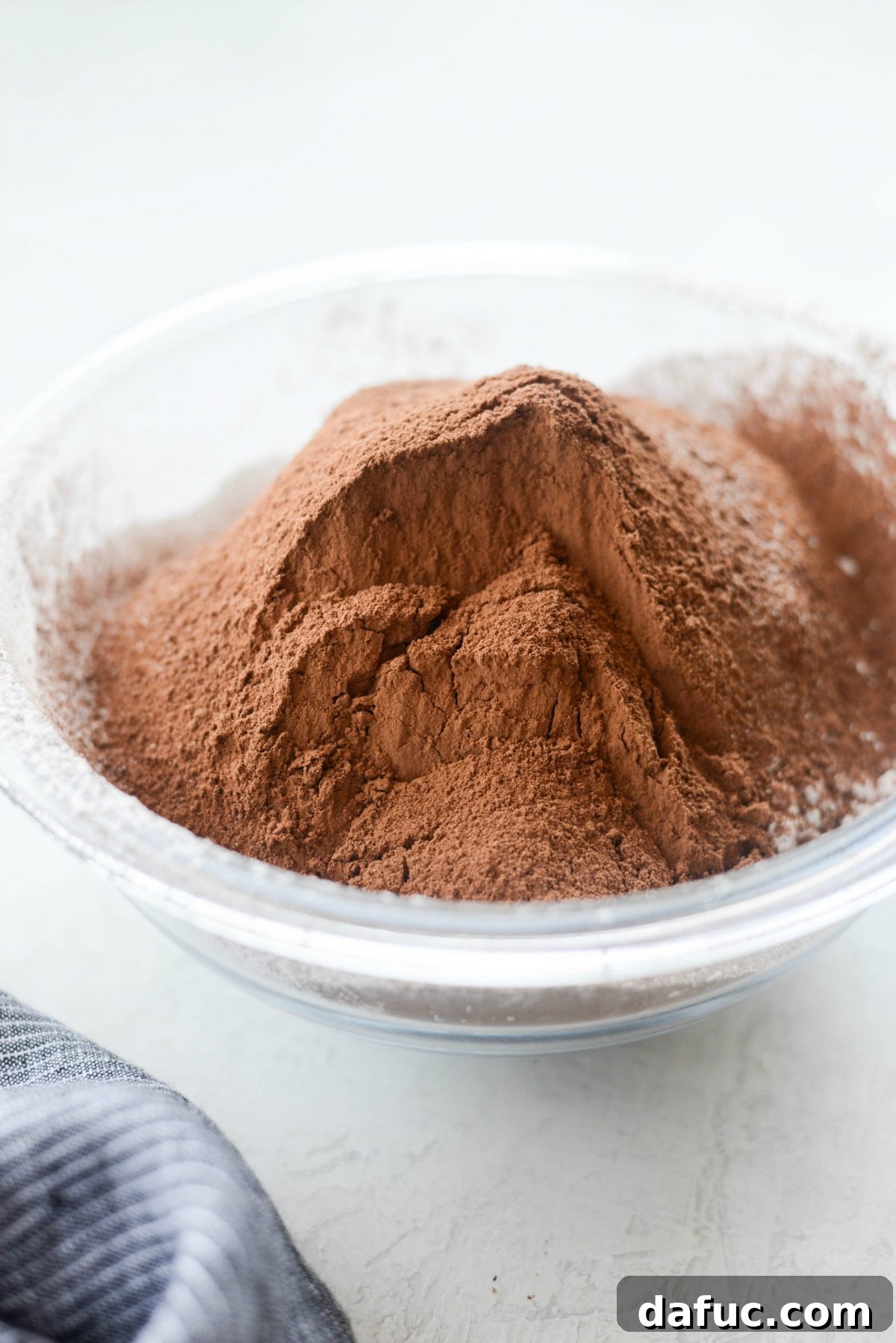 Silky Smooth Chocolate Frosting 7 Sifting unsweetened cocoa powder to ensure a smooth chocolate frosting.