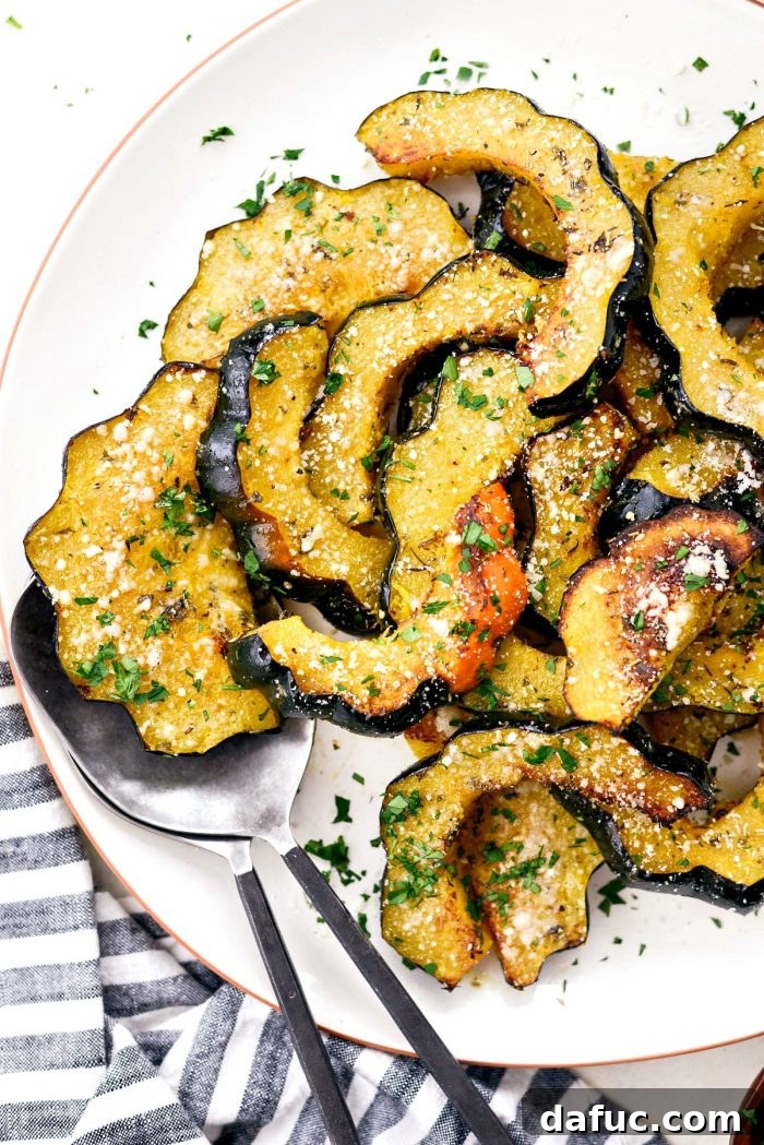 Close-up of roasted acorn squash with Parmesan and parsley.