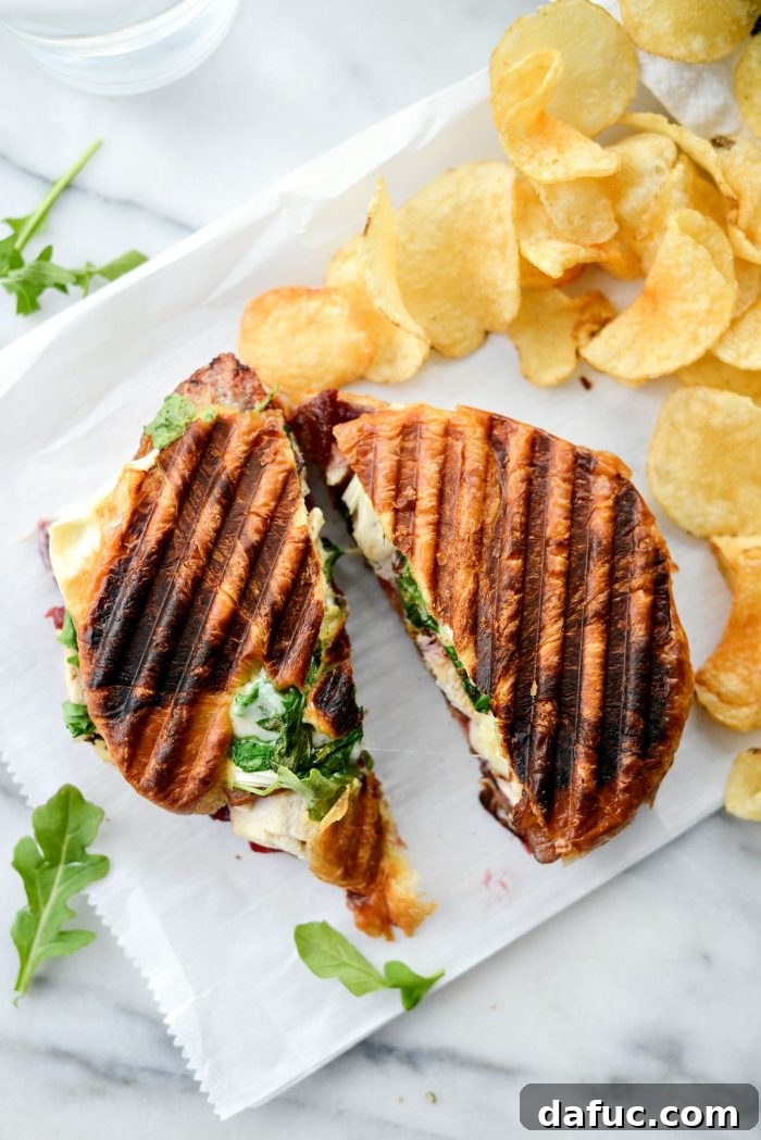 Another close-up shot of a perfectly grilled and sliced panini, highlighting the textures and vibrant colors.