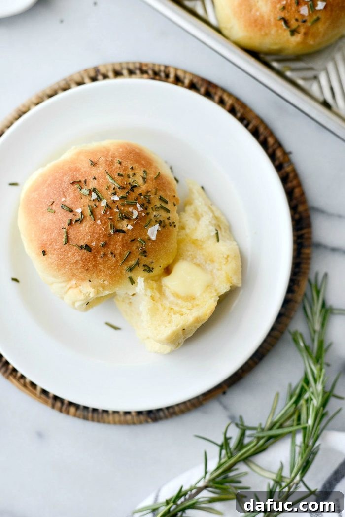 Deliciously soft Sea Salt Rosemary Dinner Rolls, perfect for any meal or holiday gathering. Homemade bread with fresh rosemary and flaky sea salt.