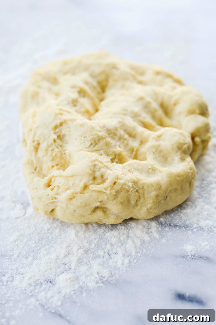 Risen dough in a bowl, showing its light and airy texture.