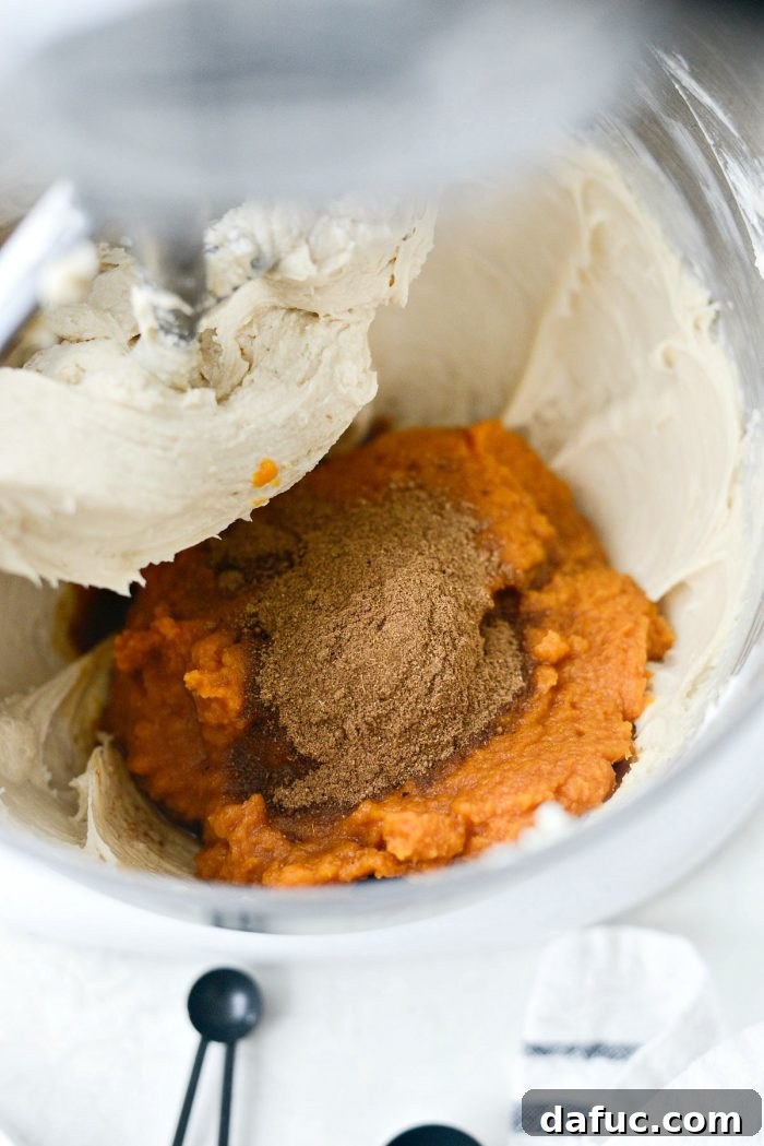 Dreamy No-Bake Pumpkin Cheesecake with a Gingersnap Crunch 11 Adding Pumpkin Puree, Vanilla, and Pumpkin Pie Spice to Cheesecake Base