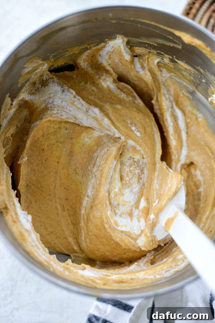 Dreamy No-Bake Pumpkin Cheesecake with a Gingersnap Crunch 14 Gently Folding Whipped Cream into Pumpkin Cheesecake Mixture