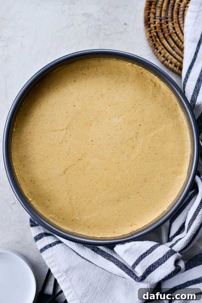 Dreamy No-Bake Pumpkin Cheesecake with a Gingersnap Crunch 16 Smooth Pumpkin Cheesecake Filling Chilling in Springform Pan