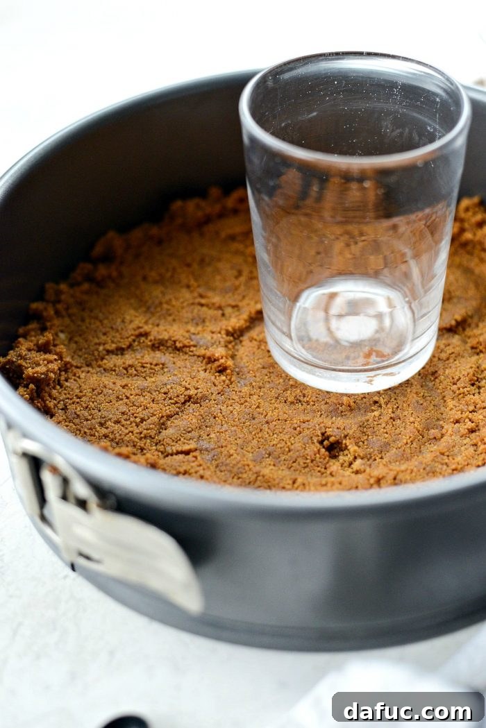 Dreamy No-Bake Pumpkin Cheesecake with a Gingersnap Crunch 7 Mixing Gingersnap Crumbs with Melted Butter for Crust