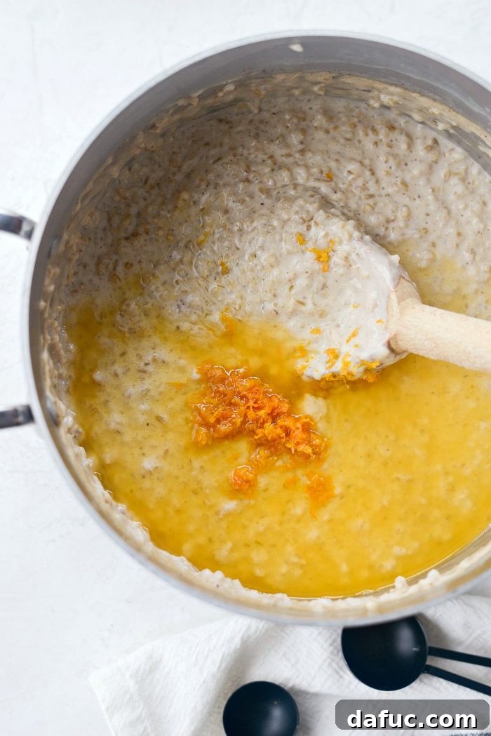 Zesty Cranberry Orange Steel Cut Oats 11 Orange zest and juice being added to the cooked steel cut oats.