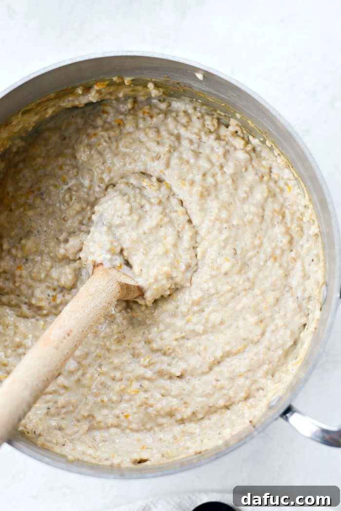 Zesty Cranberry Orange Steel Cut Oats 12 Final stir of cranberry orange steel cut oats before serving.