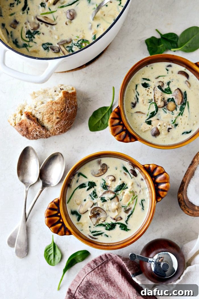 Close-up of Chicken Forester Soup, showcasing shredded chicken, mushrooms, and vibrant spinach