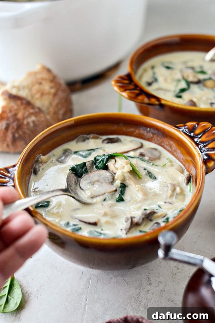 Overview shot of a rustic kitchen setting with Chicken Forester Soup in bowls