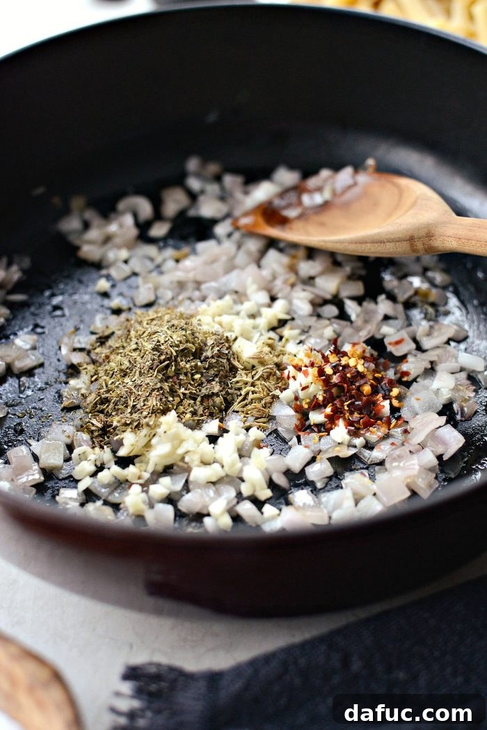 Sautéing diced shallots for the meat sauce