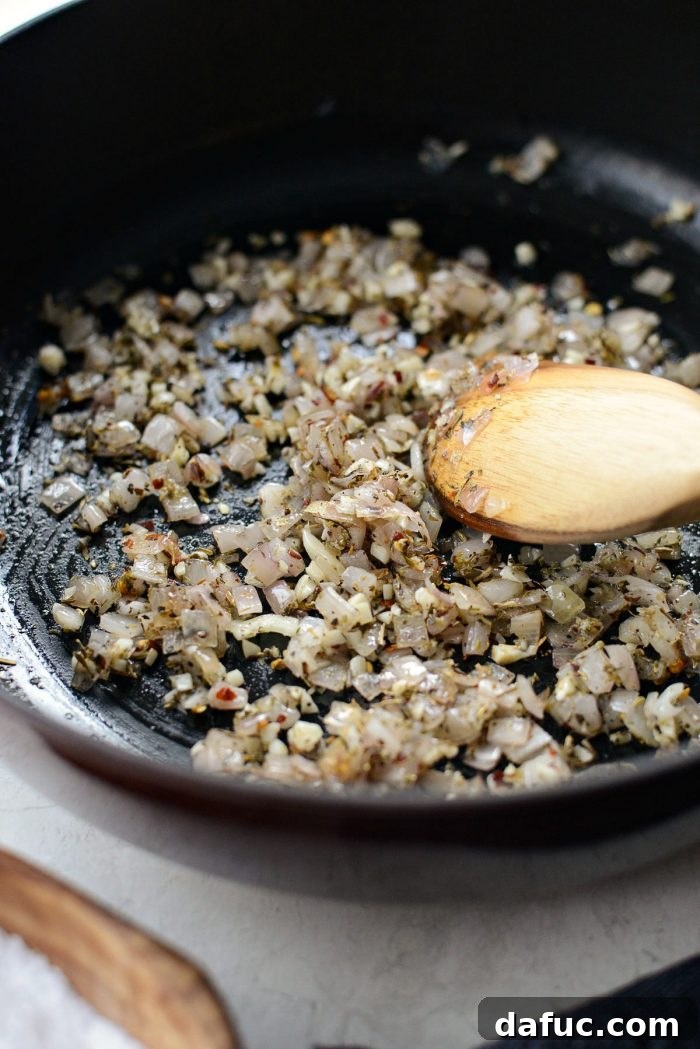 Adding minced garlic, Italian seasoning, basil, fennel, and red pepper flakes