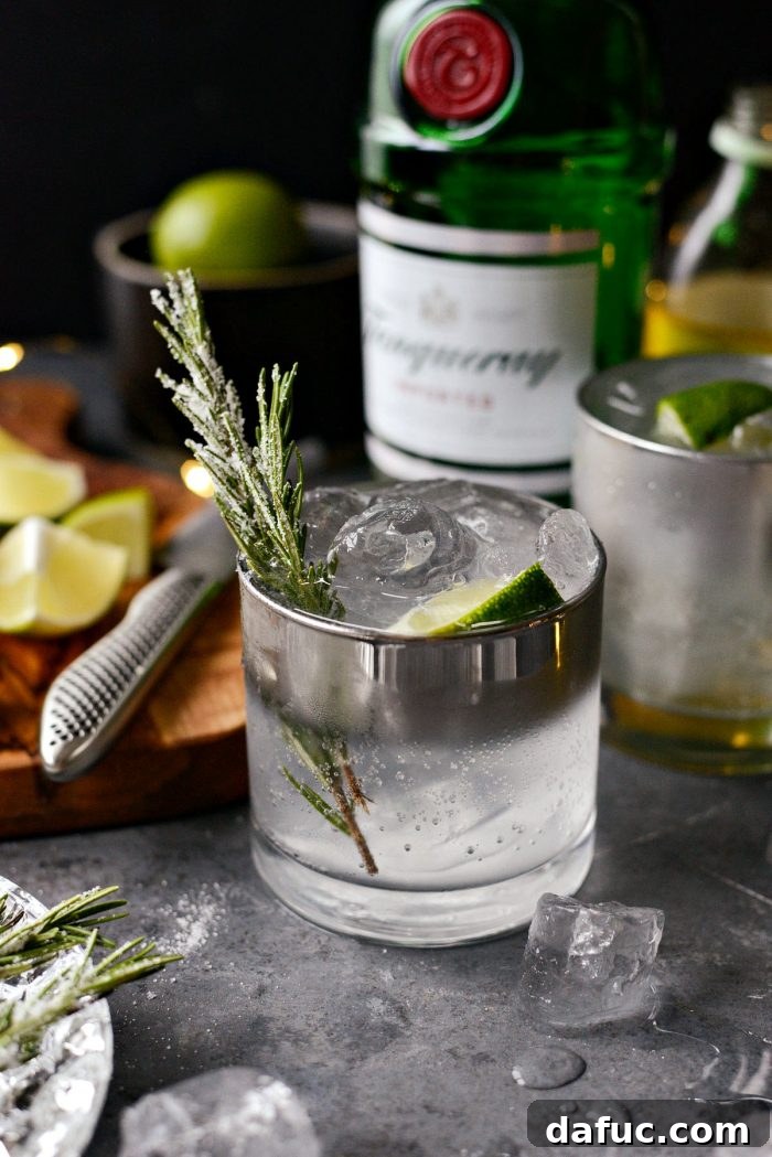 The Perfect Gin and Tonic 11 A festive Classic Gin and Tonic garnished with sugared rosemary and lime, ready to be enjoyed during the holidays.