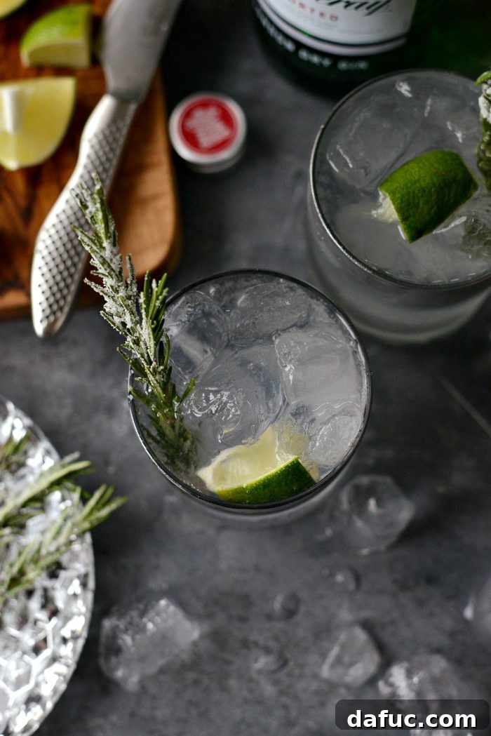 The Perfect Gin and Tonic 12 Two Classic Gin and Tonics with sugared rosemary and lime, artfully presented for a festive occasion.