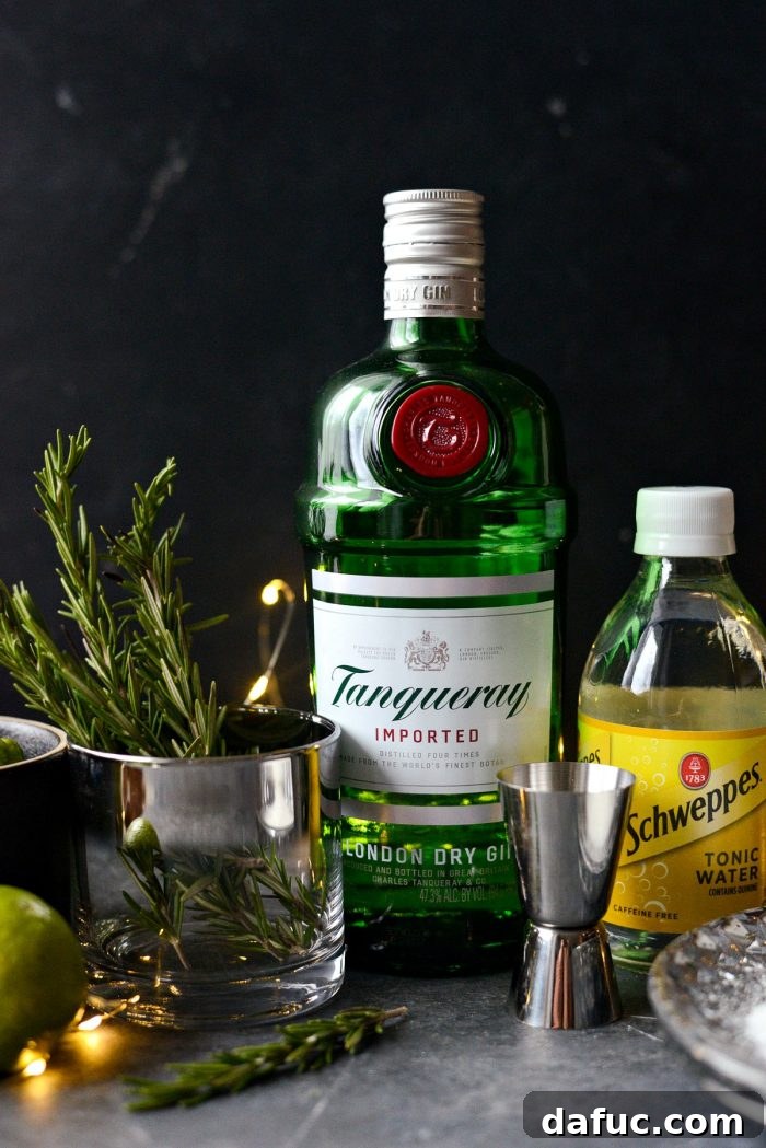 The Perfect Gin and Tonic 3 Close-up of a hand adding a lime wedge to a Classic Gin and Tonic with ice, highlighting the freshness of the ingredients.
