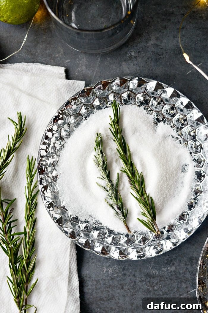 The Perfect Gin and Tonic 9 Dampening fresh rosemary sprigs with a paper towel, preparing them for sugaring.