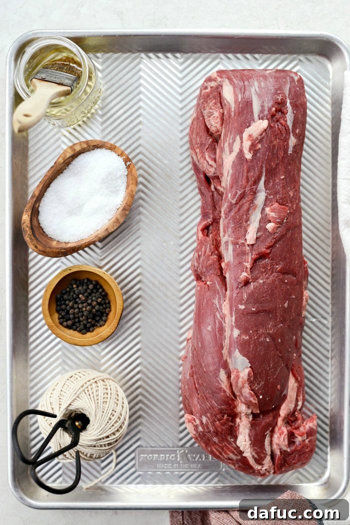 Peppercorn Crusted Beef Tenderloin 3 Beef tenderloin prepared with salt and pepper on a roasting rack.