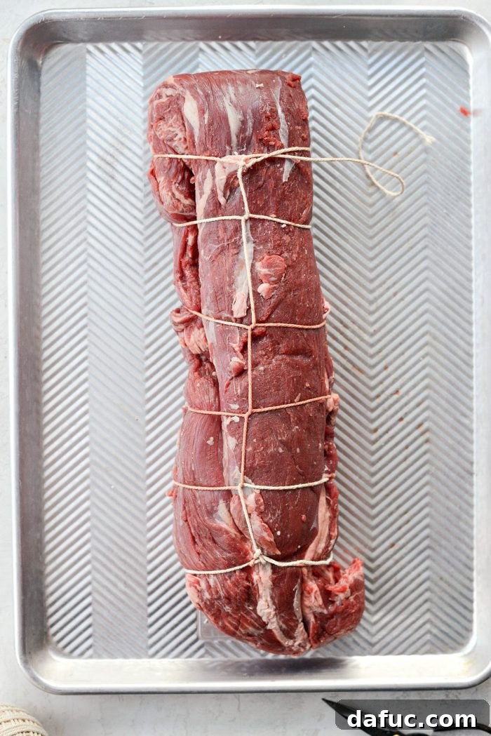 Peppercorn Crusted Beef Tenderloin 4 Instructions for folding and tying beef tenderloin for even cooking.