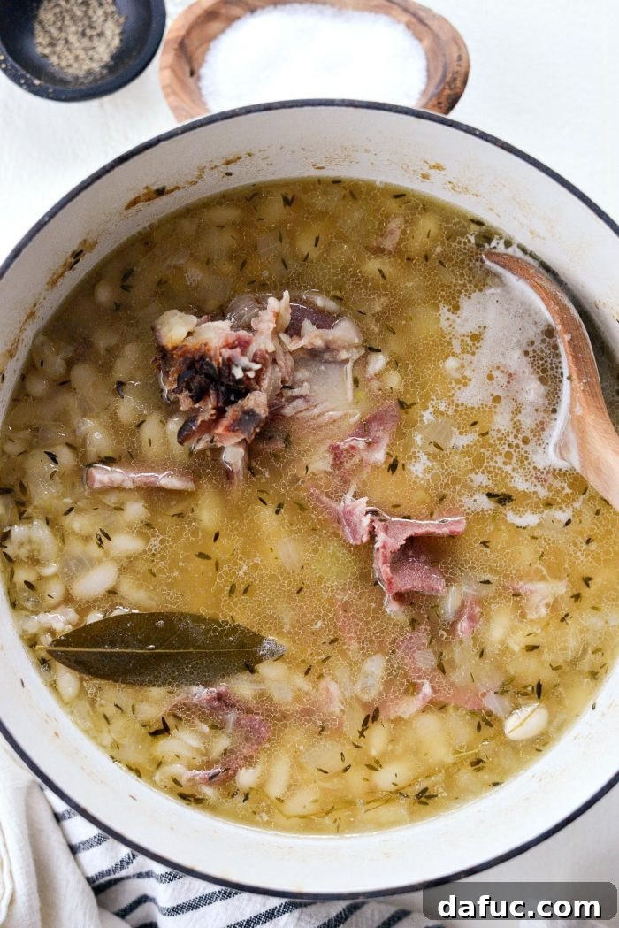 Hearty Ham and White Bean Soup 12 Cooked White Bean and Ham Soup, with tender beans and rich broth, after the long simmering process.
