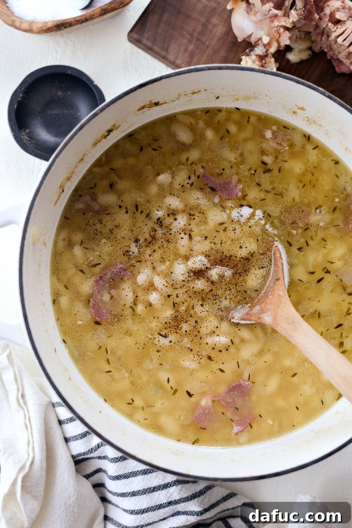 Hearty Ham and White Bean Soup 13 Ham bone, bay leaf, and thyme stems removed from the finished soup, with ham pieces added back.