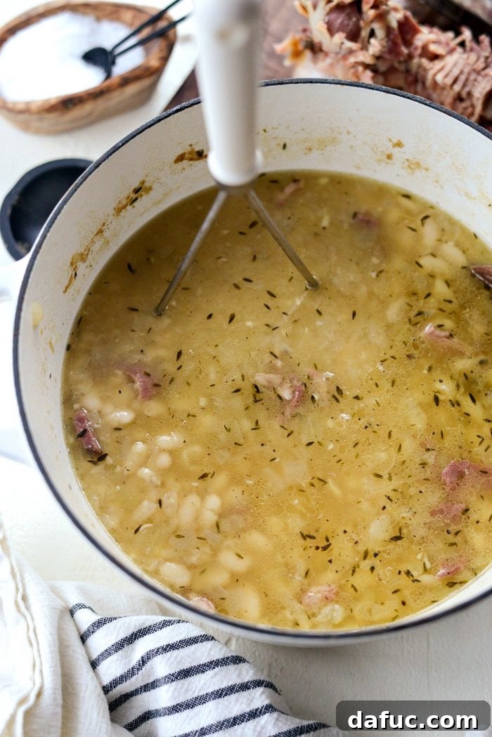 Hearty Ham and White Bean Soup 14 Seasoning the Ham and White Bean Soup with salt and freshly ground black pepper.