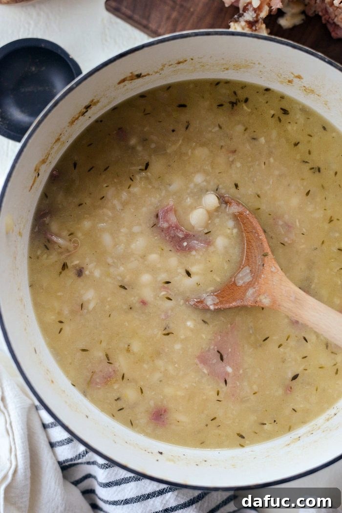 Hearty Ham and White Bean Soup 15 Mashing some of the beans in the soup with a potato masher to thicken it.