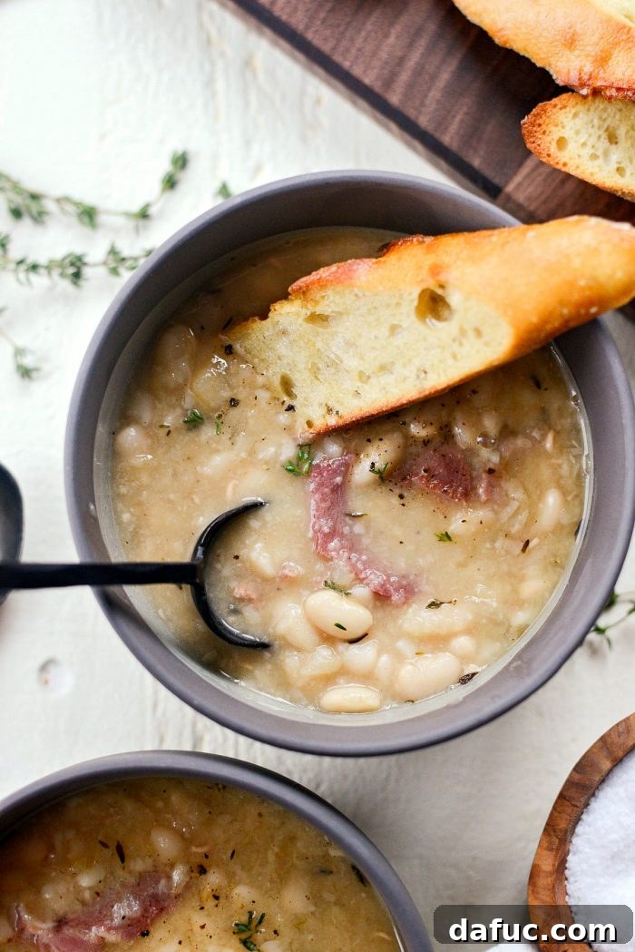 Hearty Ham and White Bean Soup 18 A bowl of Ham and White Bean Soup served with crusty bread for dipping.