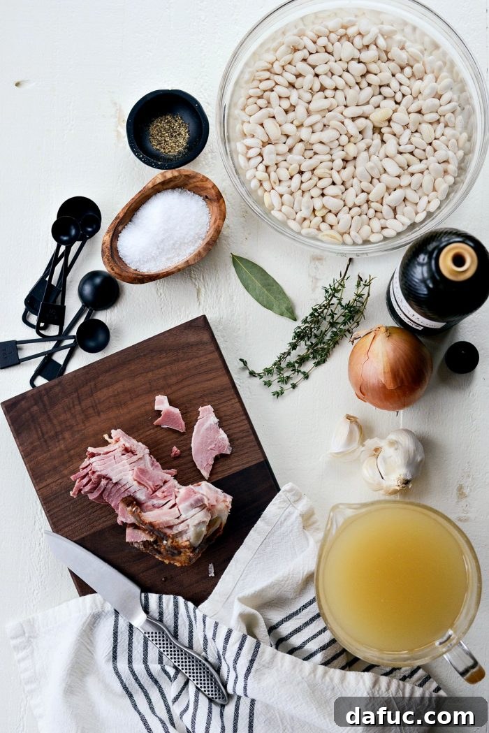 Hearty Ham and White Bean Soup 4 Serving White Bean and Ham Soup in a bowl with fresh herbs, ready to be enjoyed.