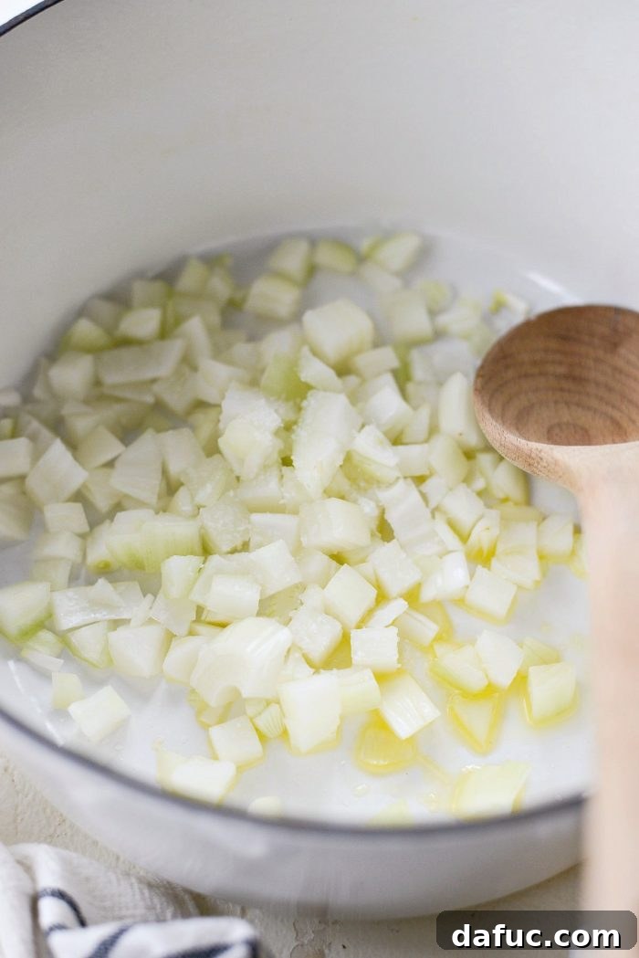 Hearty Ham and White Bean Soup 7 Sautéing diced yellow onion in a Dutch oven with olive oil and kosher salt.
