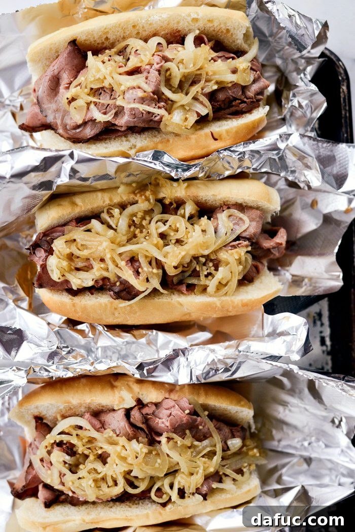 Effortless French Dip Delights 12 Roast beef being carefully placed into French rolls using tongs, allowing excess au jus to drip