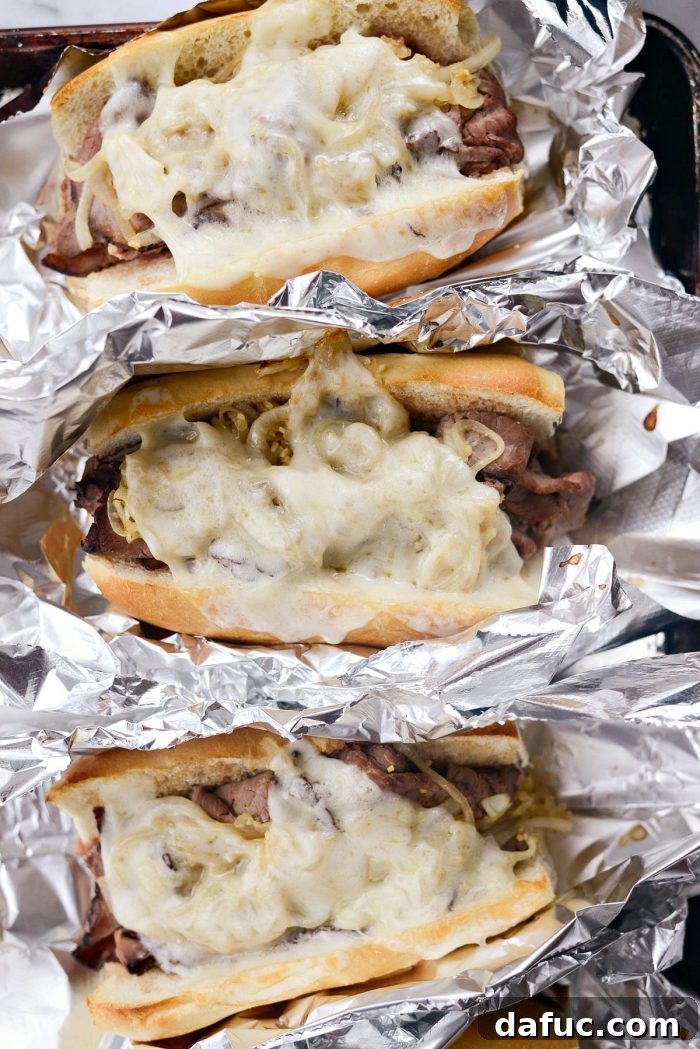 Effortless French Dip Delights 14 French Dip sandwiches topped with provolone cheese, baking in the oven until golden and melted