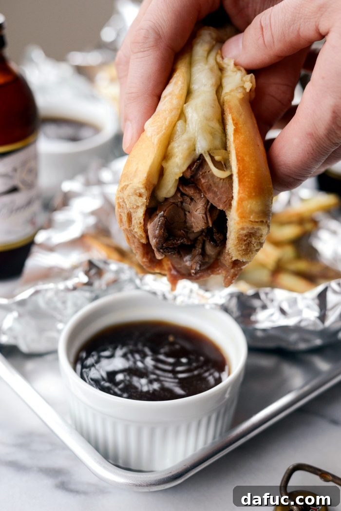 Effortless French Dip Delights 19 Enjoying a delicious French Dip sandwich, ready for another dip