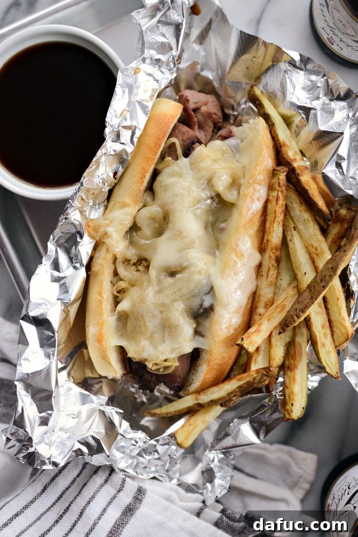 Effortless French Dip Delights 3 Close-up of a French Dip Sandwich overflowing with thinly sliced roast beef and caramelized onions