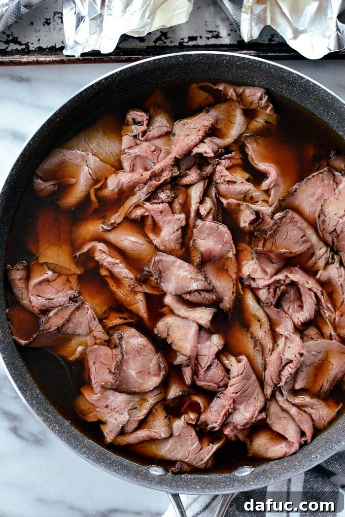 Effortless French Dip Delights 10 Beef broth and tamari simmering in a skillet to create the au jus