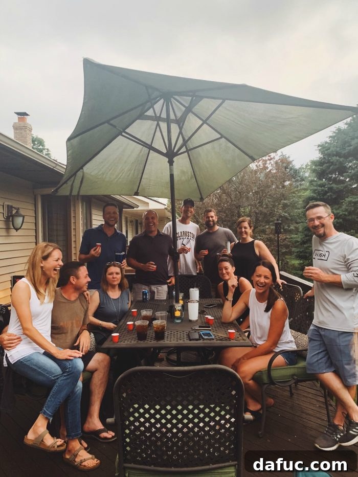 2019 Rewind 28 Friends staining a wooden deck on a hot summer day, working together