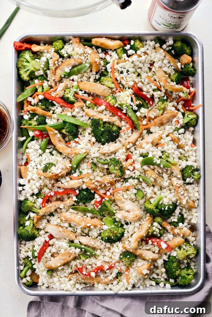 Sheet Pan Teriyaki Chicken and Cauliflower Rice with mixed ingredients on a baking sheet.