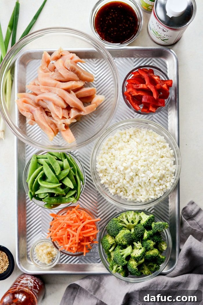 Close-up of Teriyaki Chicken and Roasted Vegetables on a sheet pan, showcasing vibrant colors.