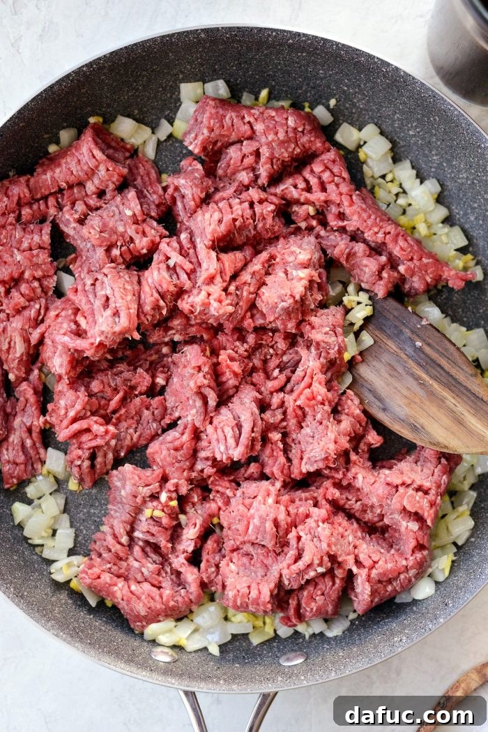Bulgogi Power Bowls 6 Onions, ginger, and garlic sautéing in a skillet, filling the kitchen with fragrant aromas