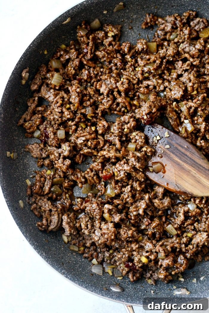 Bulgogi Power Bowls 8 Pouring homemade Korean BBQ sauce over browned ground beef in a skillet