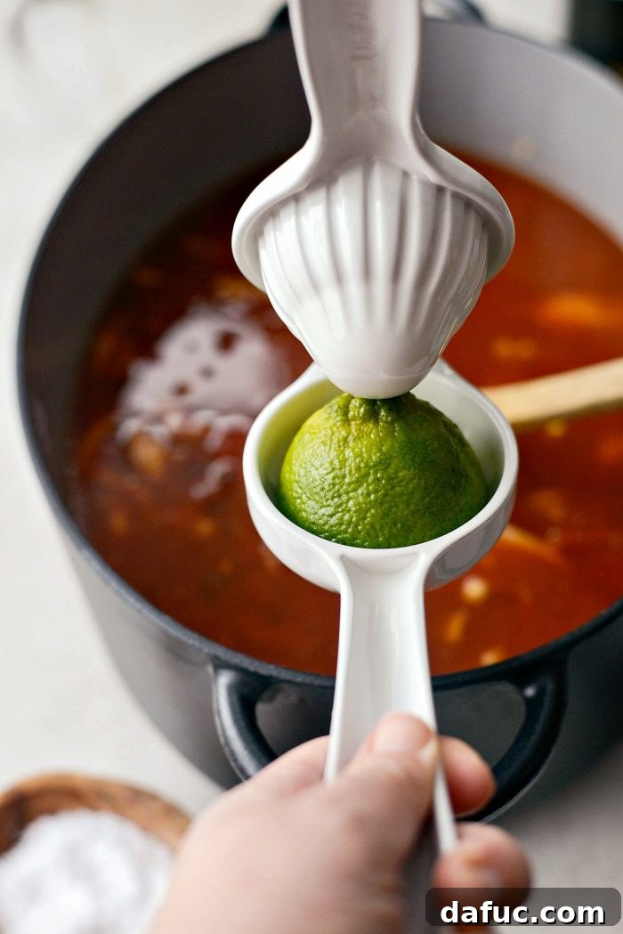 Effortless Chicken Tortilla Soup Delight 11 Minced fresh cilantro being stirred into the finished chicken tortilla soup.