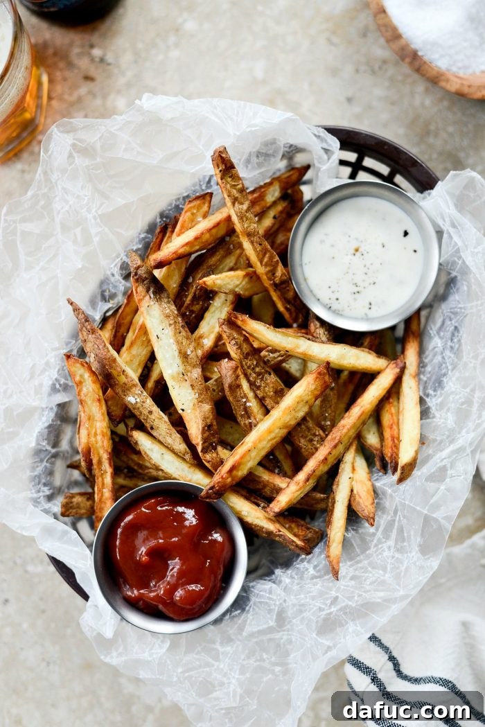 Crispy Homemade Air Fryer Fries 2 Crispy Homemade Air Fryer French Fries, golden brown and perfectly seasoned on a white plate with ketchup