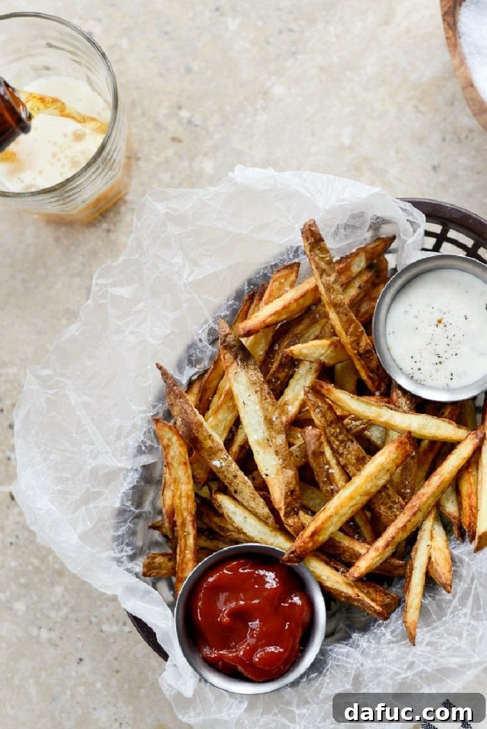 Crispy Homemade Air Fryer Fries 3 Freshly cut Russet potato sticks ready for air frying, seasoned lightly
