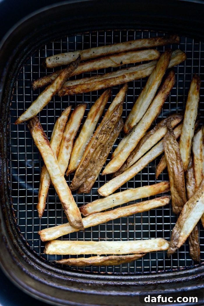 Crispy Homemade Air Fryer Fries 10 Air fryer basket being shaken to redistribute the French fries for even cooking