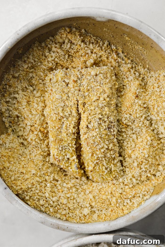 Golden Crispy Fish Sandwiches 13 Dipping fish in panko and breadcrumb mixture